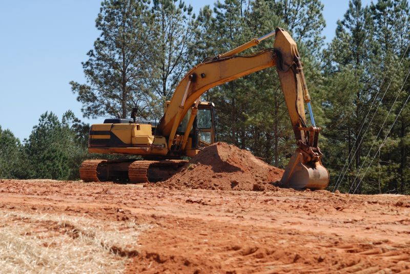 Prepares land for development and construction projects